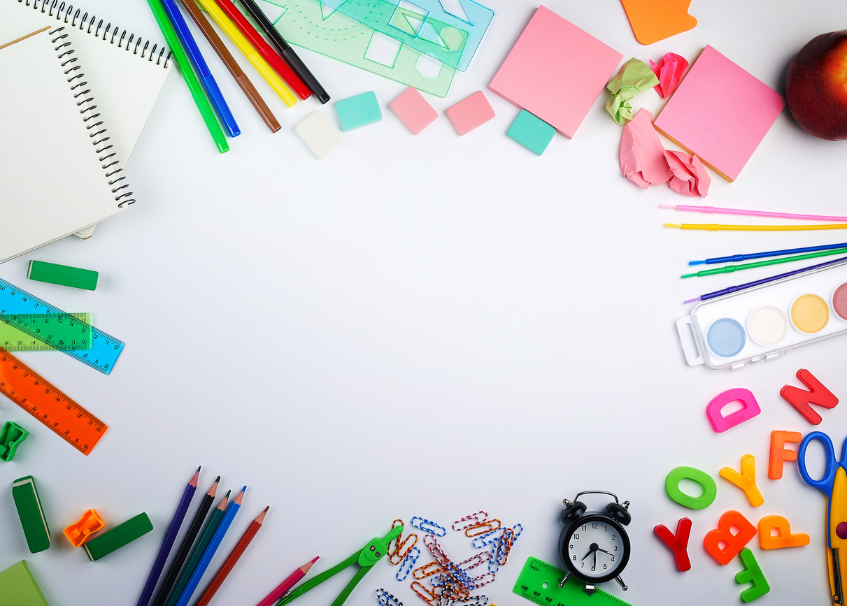 school supplies: multicolored wooden pencils, paper stickers, paper clips, pencil sharpener